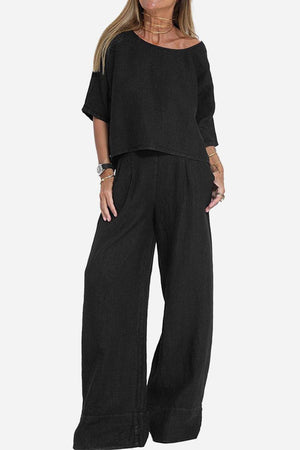 Black short-sleeved pullover and wide trouser matching set in lightweight cotton with a relaxed fit and cuffed hems.