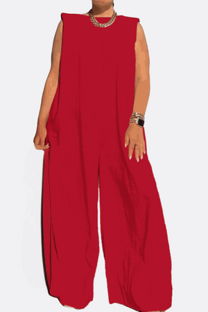 Red sleeveless wide-leg jumpsuit with a relaxed fit and sharp shoulder details, styled with gold accessories.