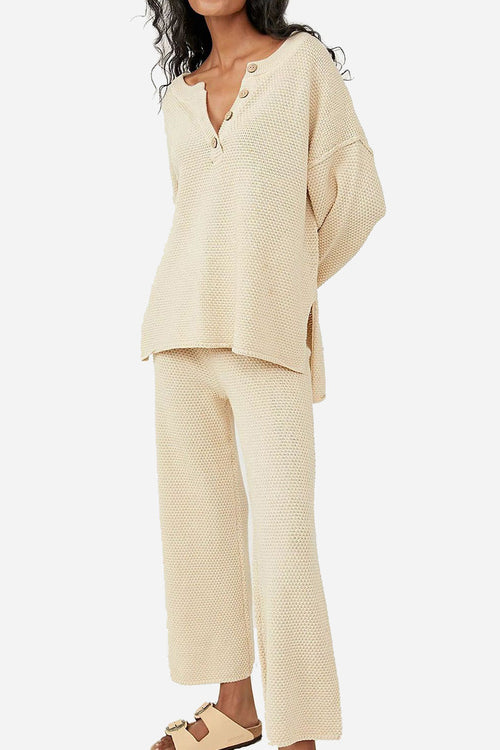 Woman wearing beige two-piece oversized set with long sleeves and wide pants for multi-weather comfort