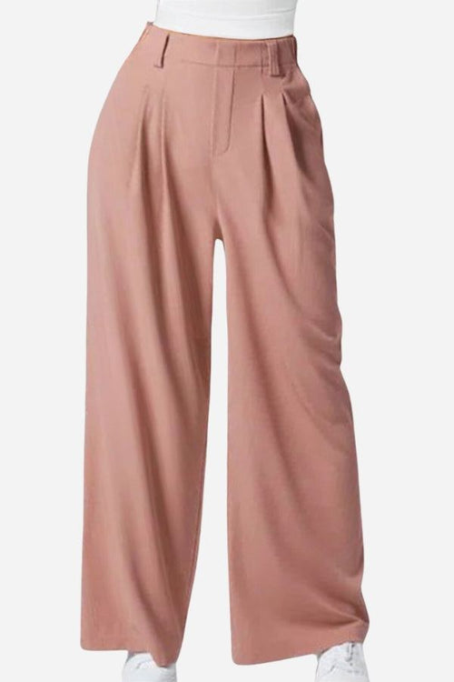High-waisted pleated wide leg waffle pants in soft pink with pockets and belt loops for a sleek, elegant European look
