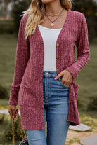 woman wearing lightweight ultra soft long knit cardigan with buttons and pockets outdoors