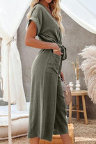 Women's V-neck lace-up pocket jumpsuit with tie in olive green, lightweight and breathable fabric, wide legs, and casual yet elegant design.