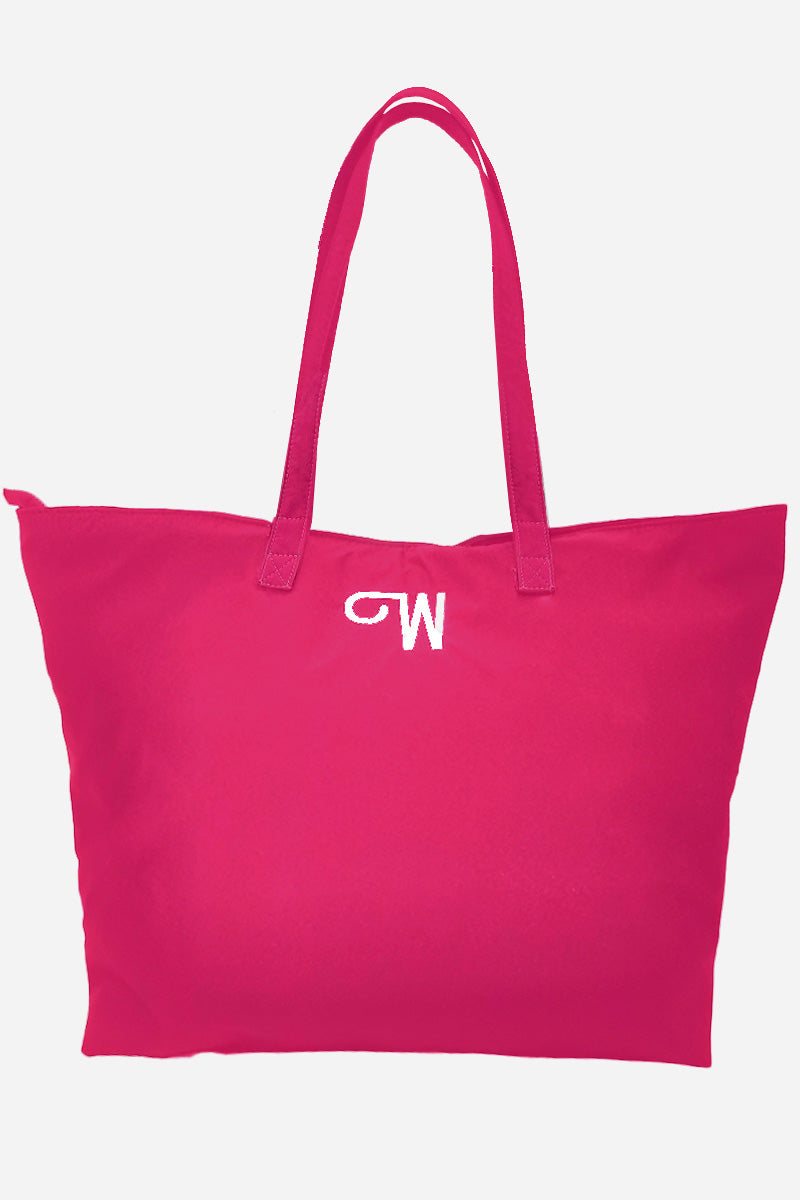 Red waterproof travel bag with long handles and embroidered logo, spacious and foldable design.