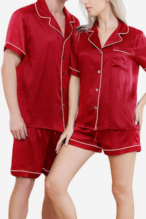 Red mulberry silk couples pajamas with short sleeves and shorts, featuring white piping trim and button-up tops.
