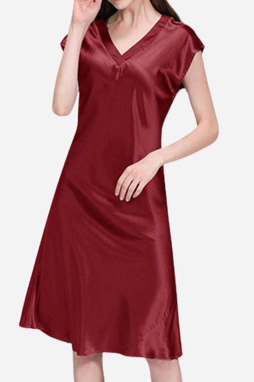 Woman wearing a burgundy Mulberry Silk V-Neck Nightgown with short sleeves and flowing silhouette.