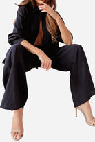 Professional black two-piece set with wide-leg pants and button-up top, styled for versatile business and casual wear