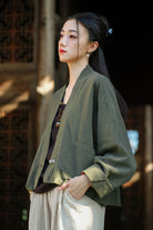 Woman wearing one size fits all ramie linen and cotton olive green cardigan with front pocket