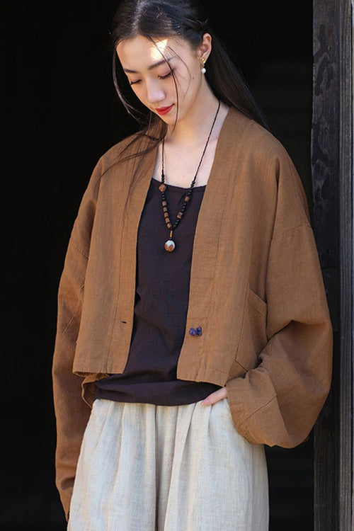woman wearing brown ramie linen and cotton cardigan with side pocket over black top and beige pants
