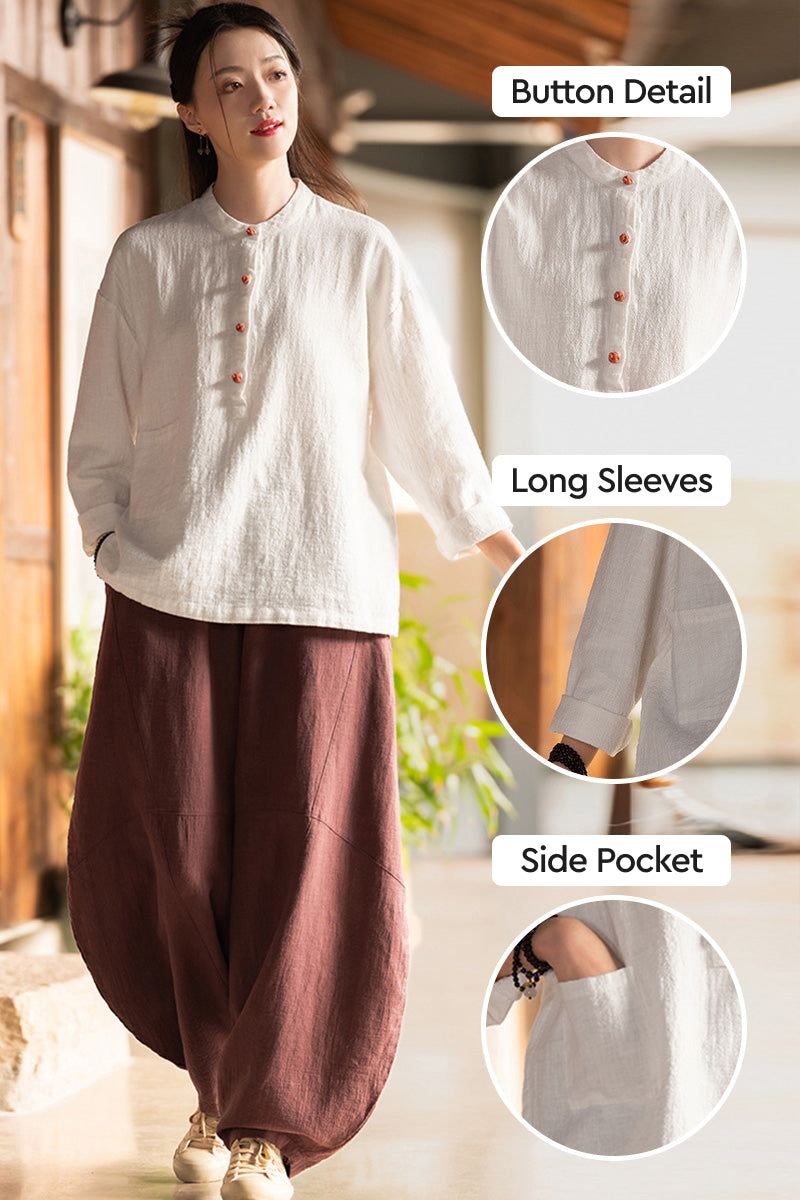 Woman wearing white ramie linen & cotton blouse with button details, long sleeves, and side pocket, styled with loose brown pants.
