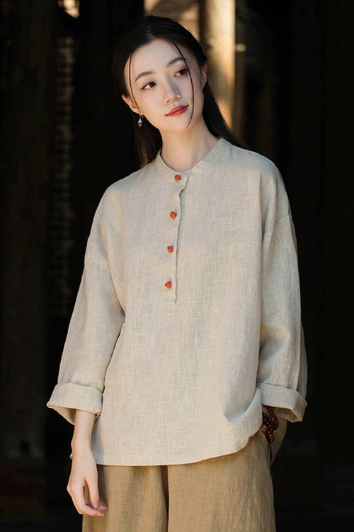 Woman wearing natural beige ramie linen and cotton blouse with long sleeves and wooden buttons