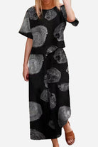 Linen and cotton loose two-piece set with black and gray abstract floral design, short sleeves top, and wide-leg pants.