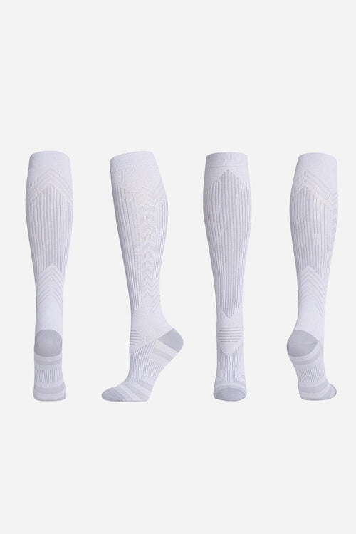 White premium compression socks shown from multiple angles for travel and leg support