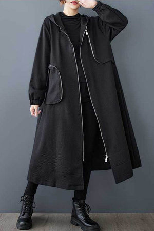 Black ZipLine oversized long coat with zippered pockets and waffle texture, modeled in casual pose, one size fits all.
