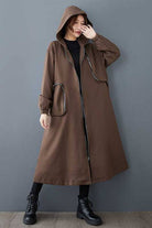 Brown ZipLine Oversized Long Coat with hood and zippered pockets, worn by woman, lightweight and travel-friendly design