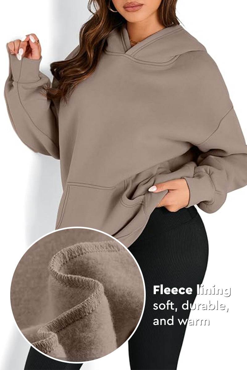 Woman wearing oversized fleece-lined hoodie in beige with cozy interior lining close-up