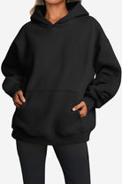 Black oversized fleece-lined hoodie with front pocket and relaxed fit for cozy warmth