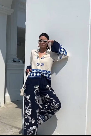 Woman wearing Mediterranean Two-Piece Set with blue and white porcelain-inspired prints, stylish and comfortable fit.