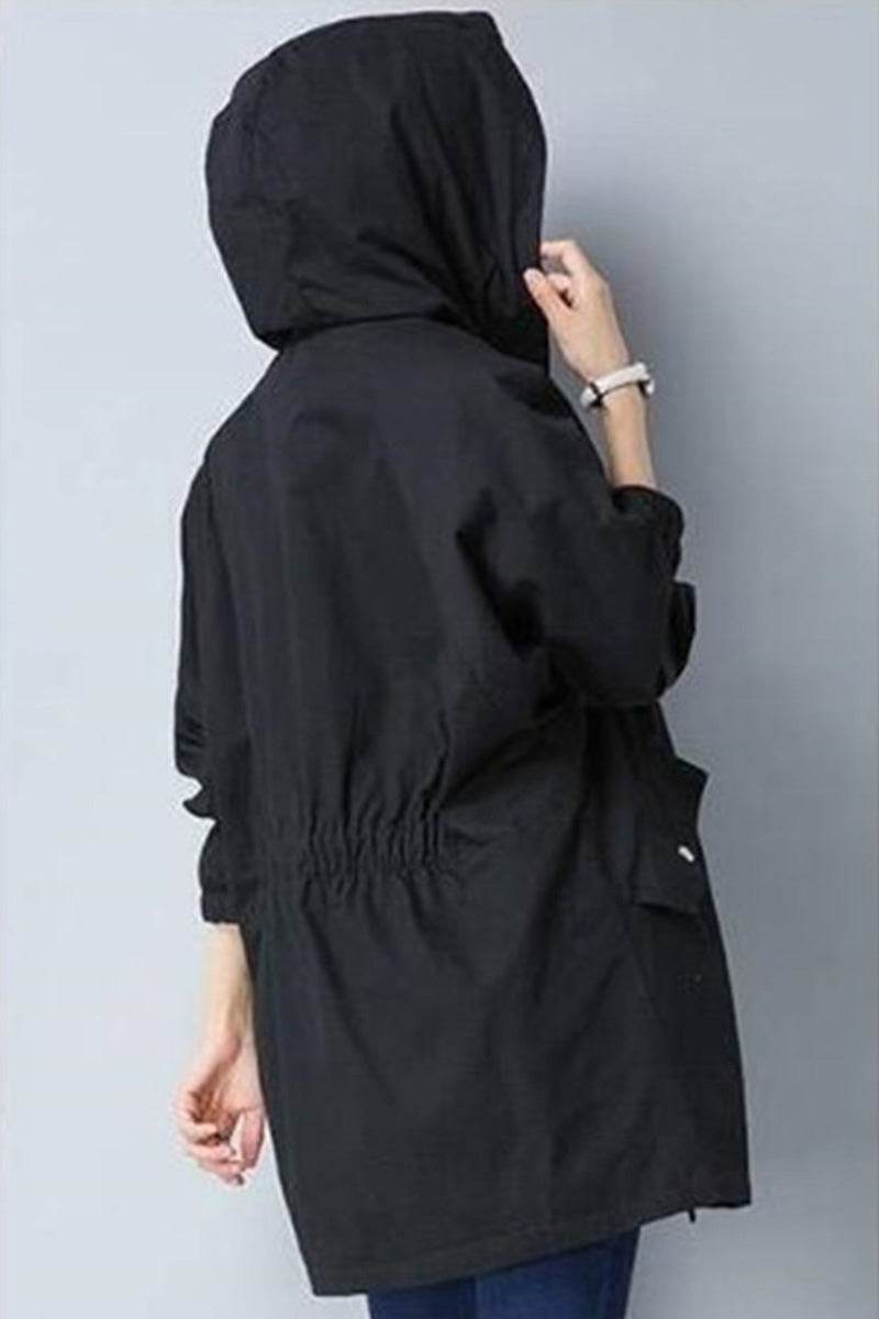 Black fashion hooded trench coat with oversized silhouette and cinched waist, lightweight and wrinkle-resistant for travel.