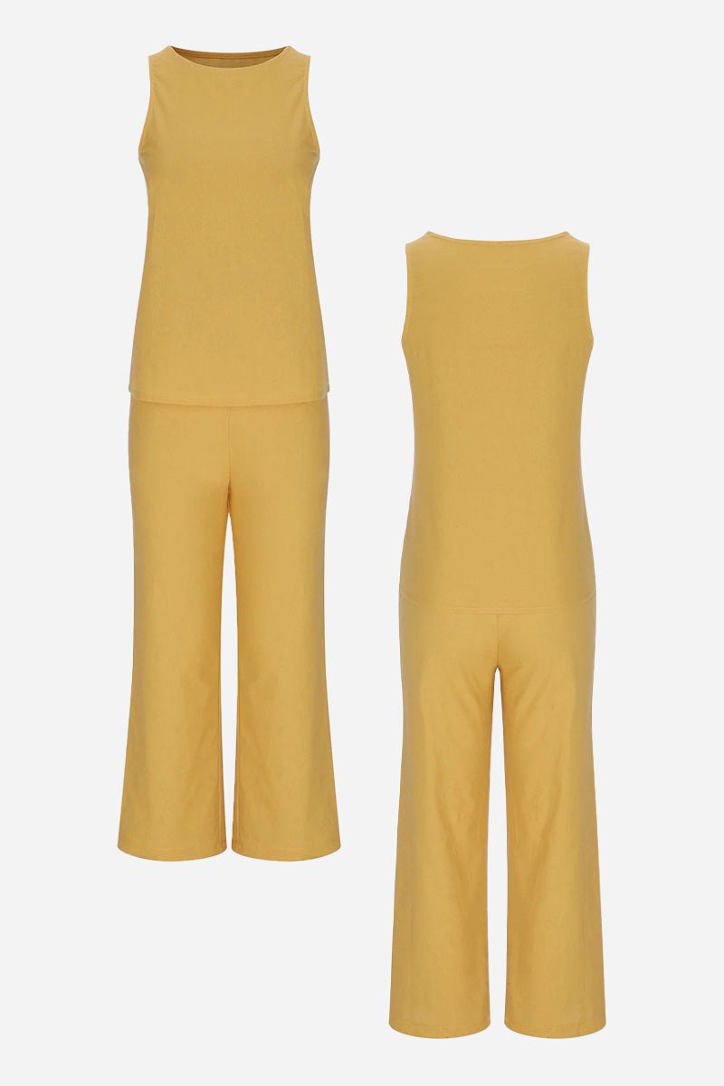 Sleek silhouette coordinated set with sleeveless top and wide-leg pants in mustard yellow, made from stretchy polyester-spandex blend for comfortable, wrinkle-resistant wear.