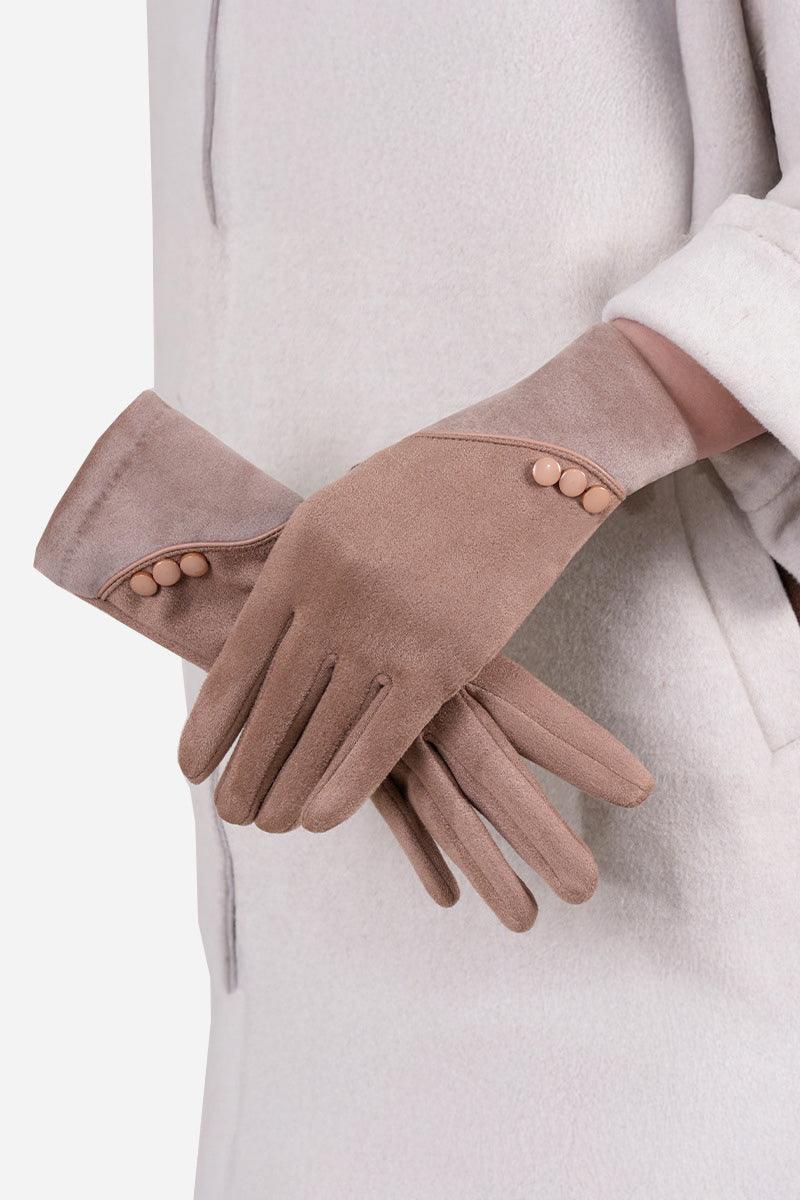 Pair of brown SmartTouch suede gloves with button detail worn on hands against a beige coat background