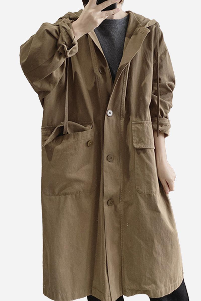 Brown travel-ready hooded windbreaker made of breathable 100% cotton with snap buttons and large pockets.