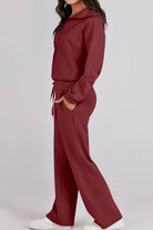 Woman wearing burgundy Loungewear Buttersoft Tracksuit Set with zip-up top and relaxed-fit pants.