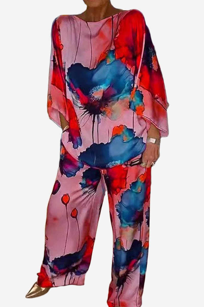 Plus size vibrant floral matching set with flowy top and pants in bold red, blue, and pink colors.