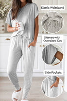 Woman wearing ultra-soft two-piece loungewear set in gray with elastic waistband, oversized cut sleeves, and side pockets