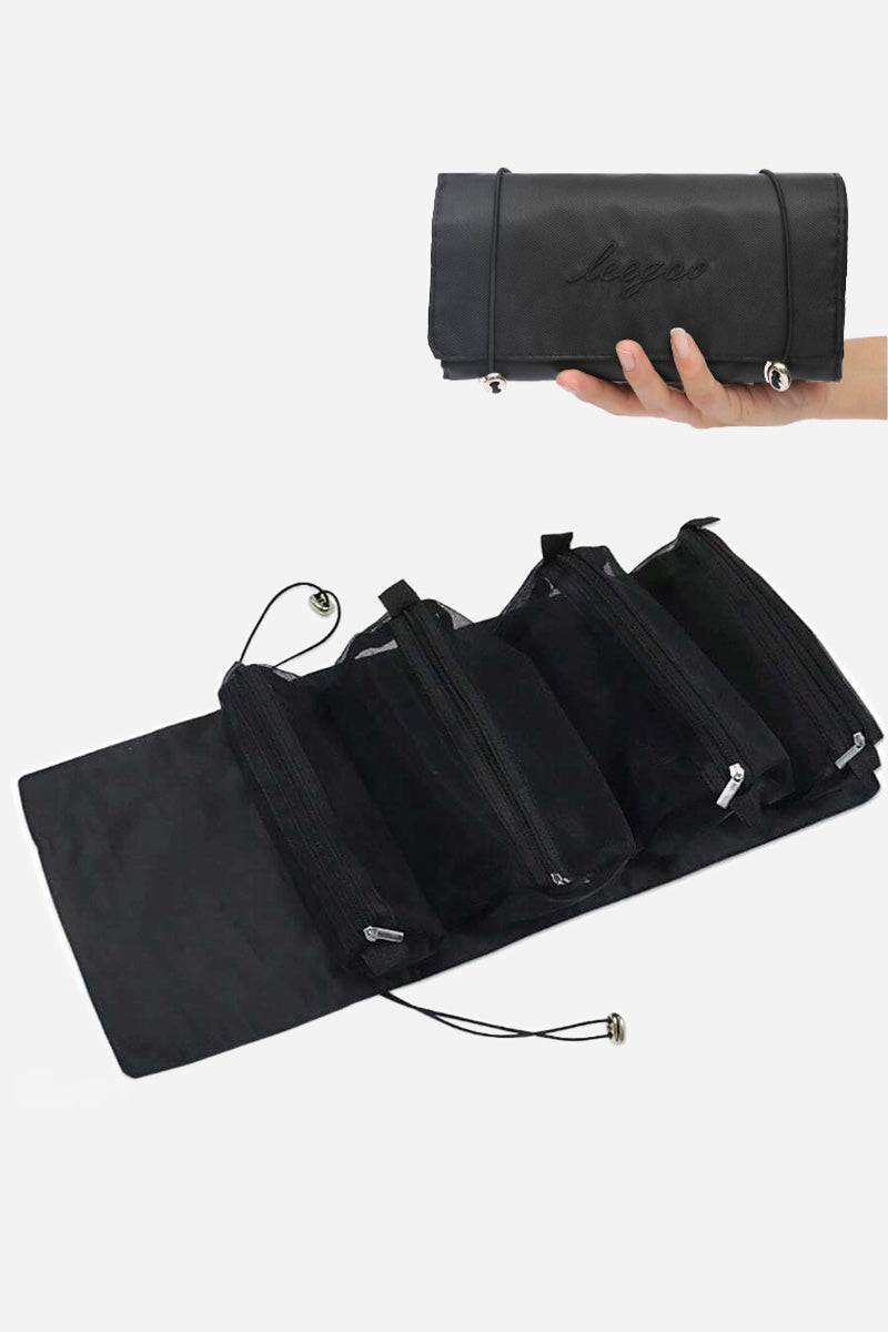 Compact black nylon Glide & Go Makeup Bag unfolded showing multiple zip compartments, held in hand for travel light look right cosmetics organization