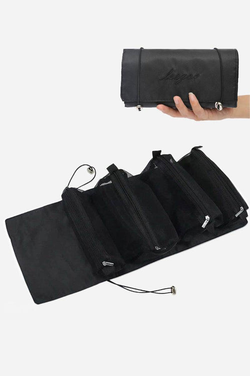 Compact black nylon Glide & Go Makeup Bag unfolded showing multiple zip compartments, held in hand for travel light look right cosmetics organization