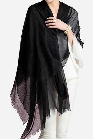 100 Cashmere Featherlight black luxury scarf draped over white outfit