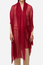 Lightweight red 100% cashmere featherlight luxury scarf worn as a wrap over beige outfit