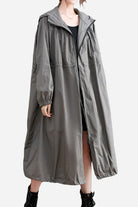 One size oversized all-weather water-resistant windbreaker in neutral color, long and roomy design for comfortable layering and weather protection.