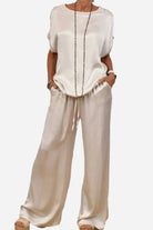 Silken Escape satin two-piece set with loose top and wide-leg pants in light beige satin fabric.