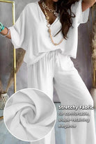 White two-piece pantsuit with V-neck and stretchy polyester fabric for comfortable, elegant fit
