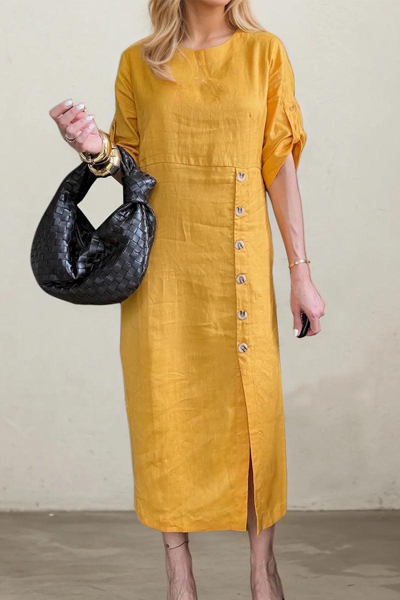 Woman wearing mustard yellow pure cotton elegance dress with side buttons and carrying black woven handbag