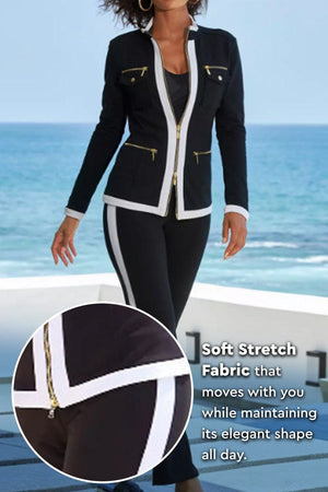 Women's sleek black Contrast Zip Two-Piece with white trim and gold zipper details by the ocean