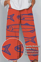 Artistic sardine pattern breathable cropped pants in orange with blue fish design and gentle stretch fabric