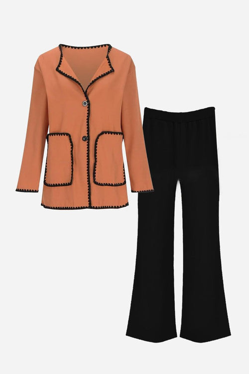 Coral and black contrast-trim knit cardigan set with button front and matching black pants for comfortable all-day wear