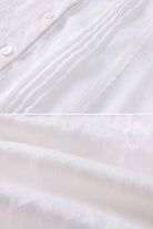 close-up of white 100% linen fabric with button and pleated details for coastal shift dress