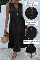 Bohemian tiered midi dress in black with V-neck, button detail, empire waist, and flowing tiered skirt.