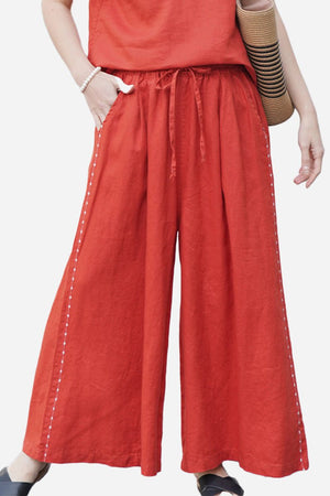 Wide-leg 100% linen pants in burnt orange with drawstring waist and side stitch detailing