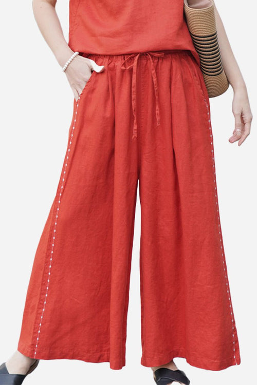 Wide-leg 100% linen pants in burnt orange with drawstring waist and side stitch detailing