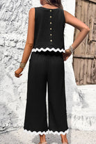 Black scalloped trim sleeveless top and wide leg pants set with button back and white scalloped edges.