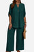 Wrinkle-free wide leg pants and button-front top travel outfit in dark green polyester fabric