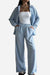 Woman wearing light blue relaxed fit wide-leg two-piece set with open shirt and elastic waist pants