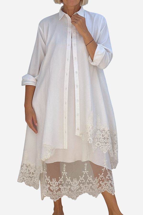 Woman wearing Villa Breeze Dress and Cardigan Set in white with lace details on hem and sleeves.