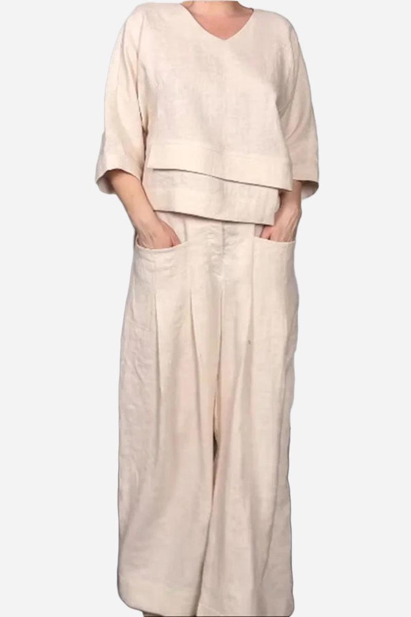 Woman wearing Atelier Serenity layered two-piece set in neutral beige with relaxed fit and wide-leg trousers