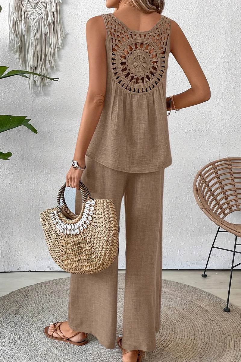 Woman wearing Dreamcatcher Crochet-Back beige sleeveless top and wide-leg palazzo pants set with woven bag and sandals.