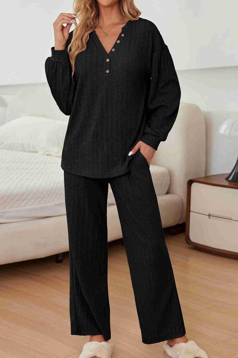 Woman wearing black Desert Bloom Ribbed Comfort Set lounge outfit with V-neck and wide-leg pants indoors